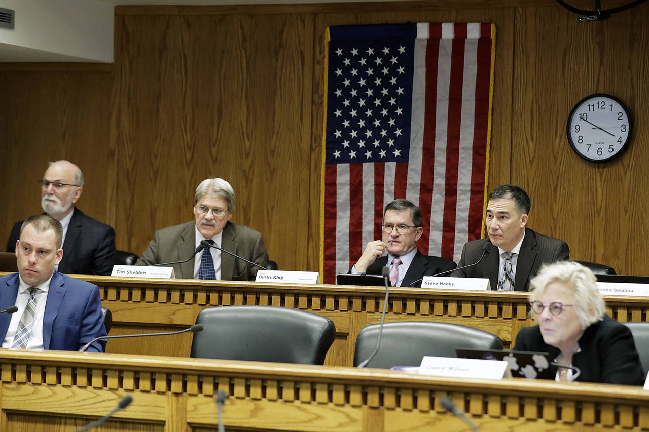 Members of the state Senate Transportation Committee, including chairman Sen. Steve Hobbs, D-Lake Stevens, (right), listen during a Feb. 4, hearing at the Capitol in Olympia, Wash., regarding proposed legislation regarding I-976. (Ted S. Warren / Associated Press)