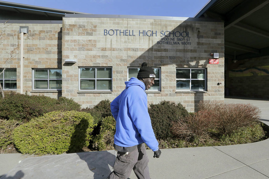 A school janitor opens the door to a staff room inside Bothell High School, which was closed for the day, on Thursday. The school was closed after a staffer’s family member was placed in quarantine for showing symptoms of possibly contracting coronavirus. (Elaine Thompson / Associated Press)
