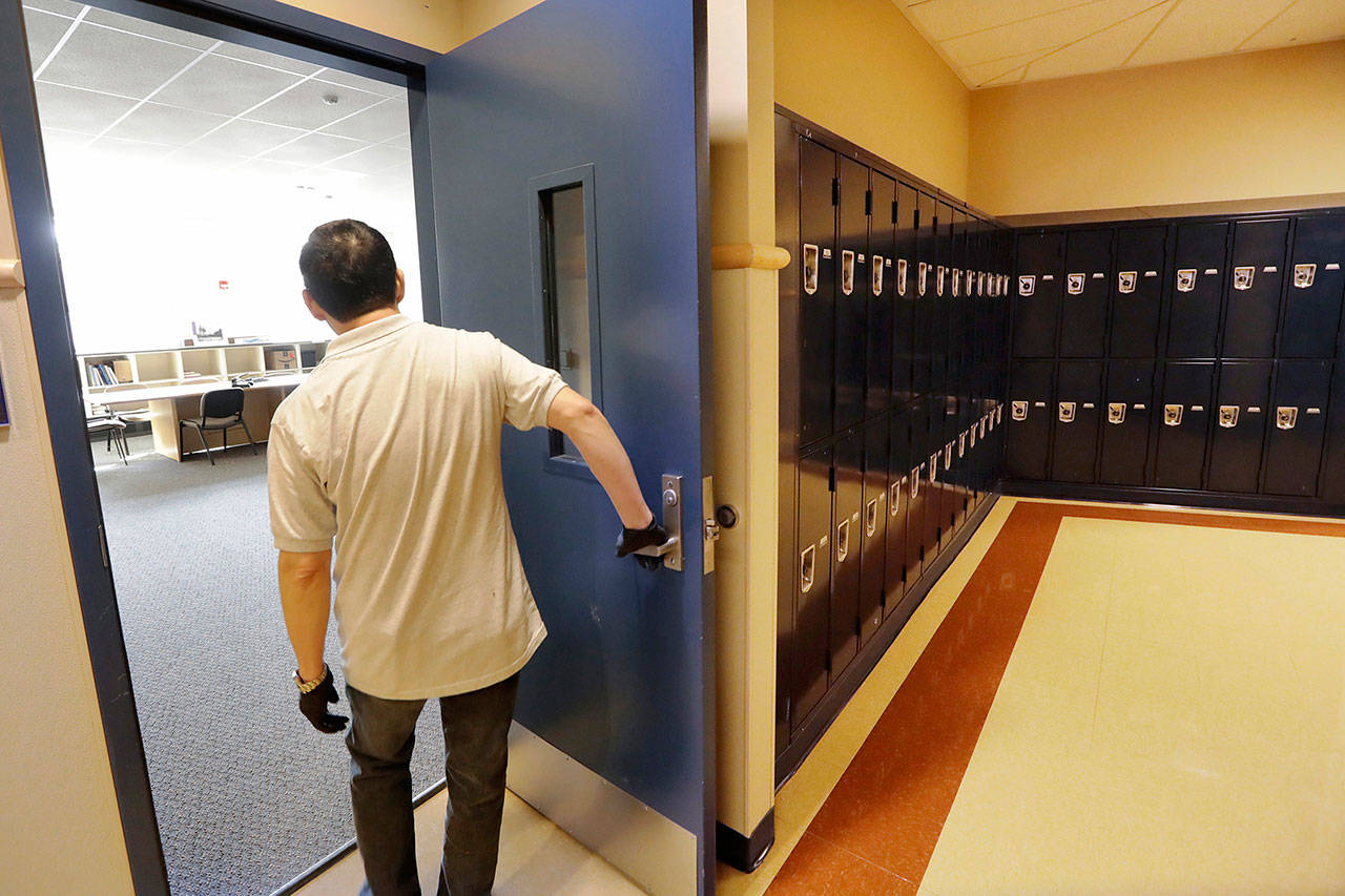 A school janitor opens the door to a staff room inside Bothell High School on Thursday. (AP Photo/Elaine Thompson)