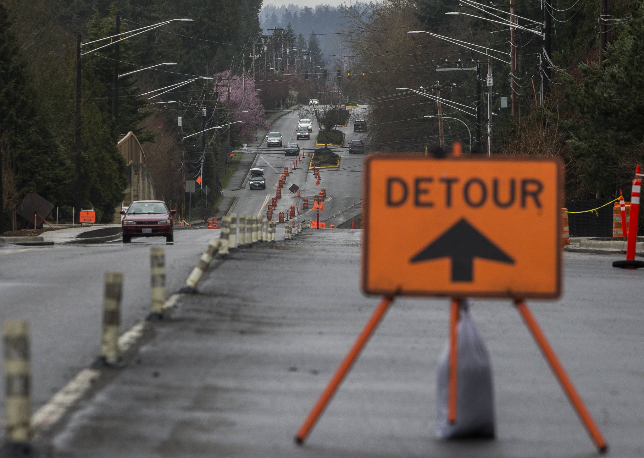 Cars merge and navigate the construction along 36th Avenue West on March 13 in Lynnwood. The road project is nearing completion. (Olivia Vanni / The Herald)