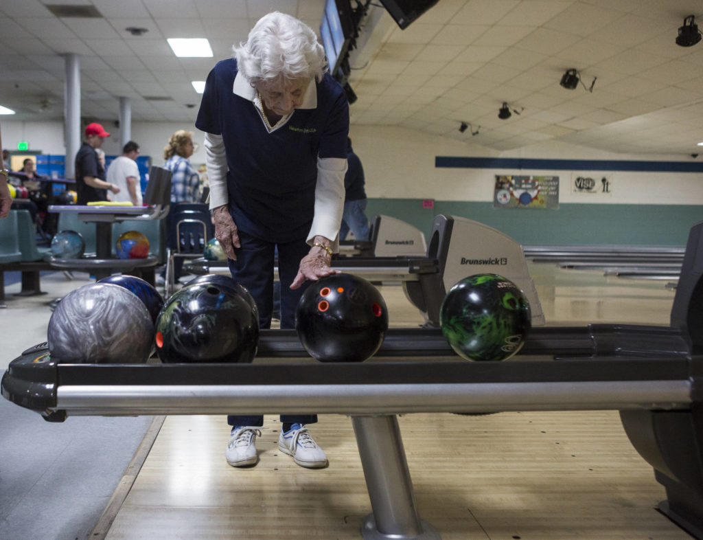 Carol Perry waits for her bowling ball to be returned during league bowling. (Olivia Vanni / The Herald)
