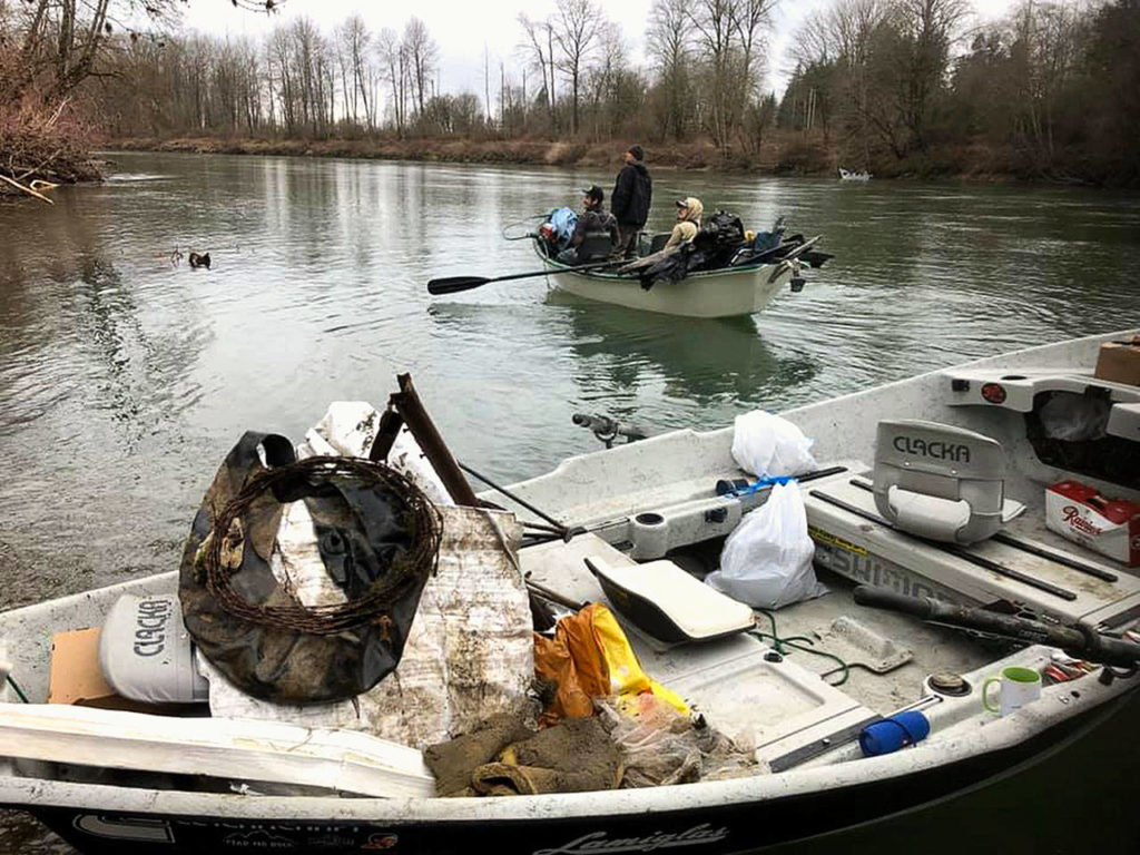 Members of the Sky River Anglers collect garbage from the banks of the Skykomish River between Sultan and Monroe on March 1. (Matthew Kennedy)
