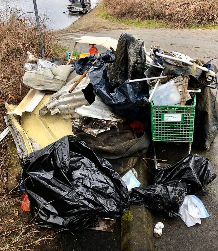 Trash collected March 1 by members of the Sky River Anglers came from recent flooding, a homeless encampment and illegal dumping. The group used their their boats in the volunteer effort. (Matthew Kennedy)
