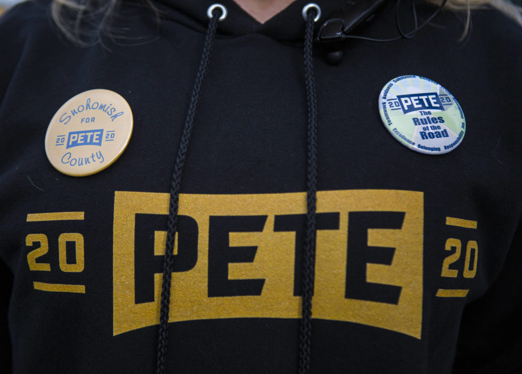 A Pete Buttigieg supporter wears pins and a sweatshirt on Feb. 29 in Everett. (Olivia Vanni / The Herald)
