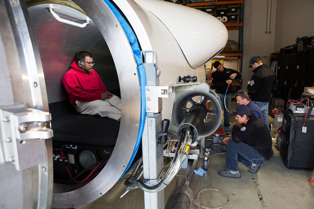 OceanGate engineer Mark Walsh programs control software as engineering technicians get the Titan submersible ready for testing on March 12, 2018, in Everett. (Andy Bronson / Herald file)
