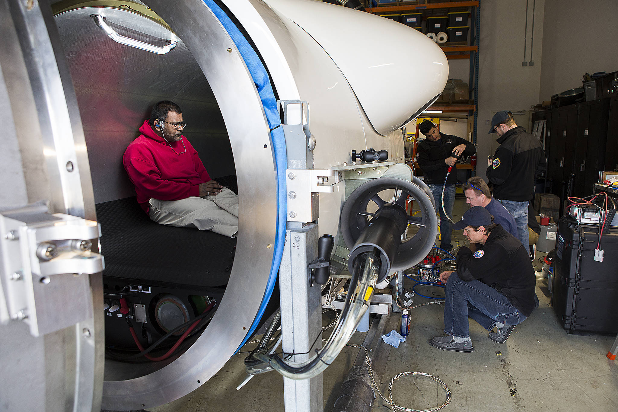 OceanGate engineer Mark Walsh programs control software as engineering technicians get the Titan submersible ready for testing on March 12, 2018, in Everett. (Andy Bronson / Herald file)