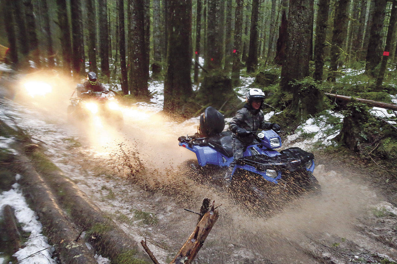 Norma Vasquez makes a splash in the Reiter Foothills State Forest on a tour led by Index-based Chinook ATV Expeditions. (Kevin Clark / The Herald)