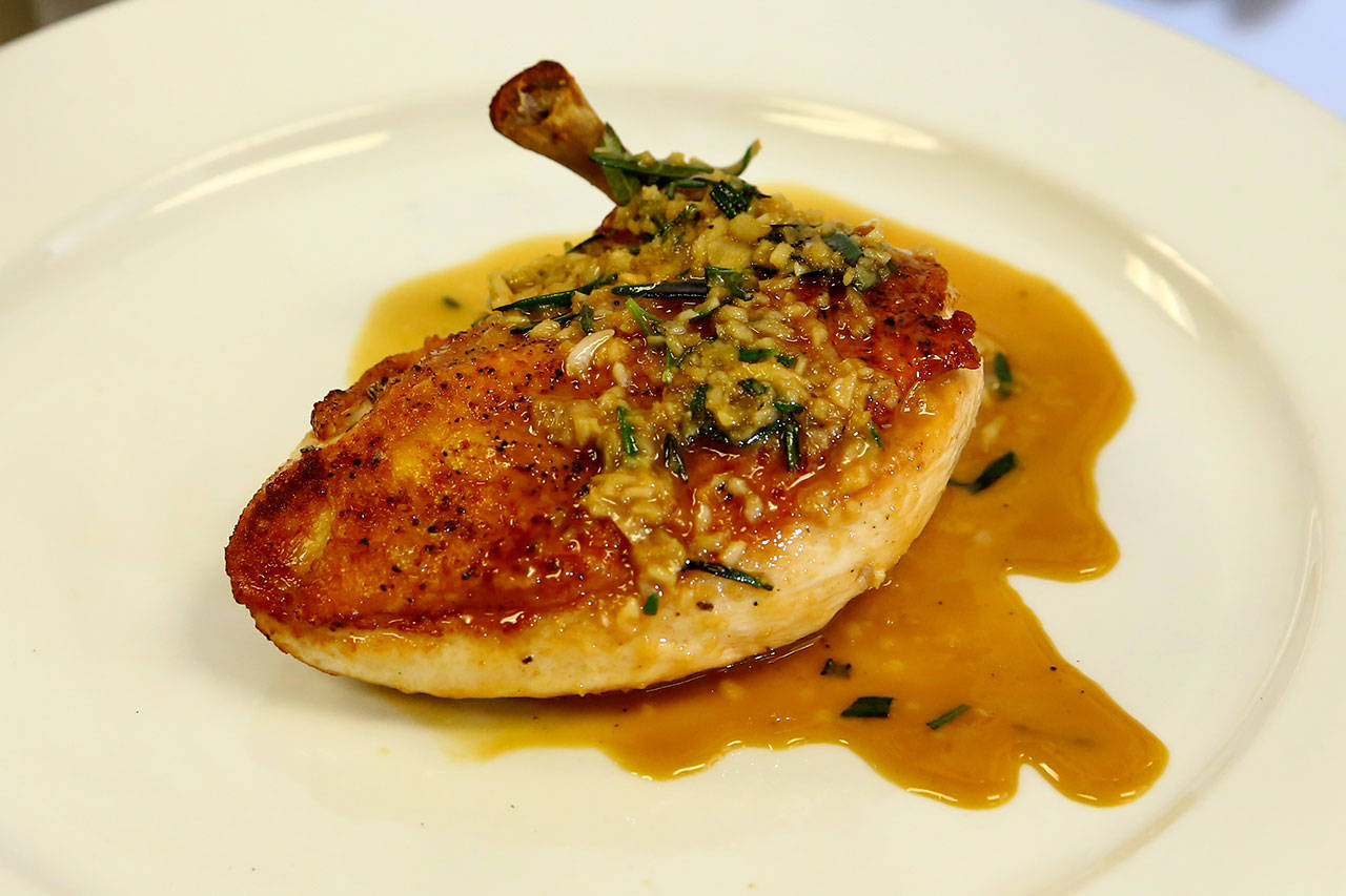 Russell’s pan-seared chicken breast with rosemary-garlic sauce features an “airline” cut breast, meaning the wing bone is still attached. (Kevin Clark / The Herald)