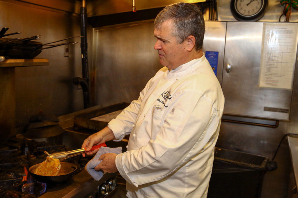 Russell Lowell says his pan-seared chicken breast with rosemary-garlic sauce is his favorite dish to cook. (Kevin Clark / The Herald)
