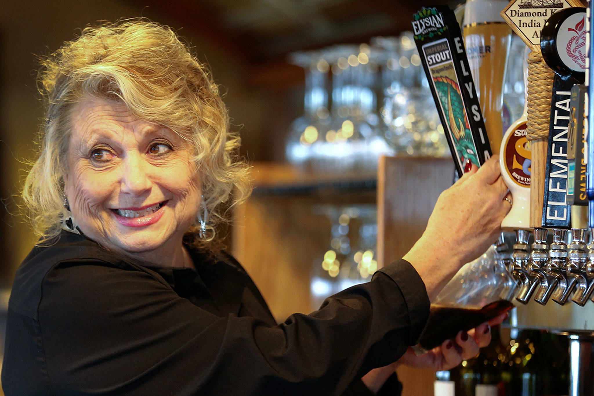 Nancy Myrtle has tended bar at Arnies Pacific Northwest Favorites of Mukilteo for 33 years. (Kevin Clark / The Herald)