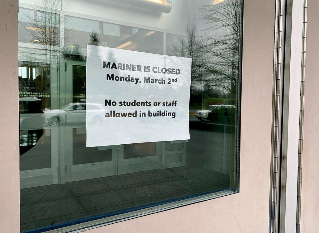 A sign warns people to stay out of Mariner High School near Everett, which was closed for cleaning Monday after a student’s family member tested positive for the COVID-19 virus. (Andrea Brown / The Herald) 
