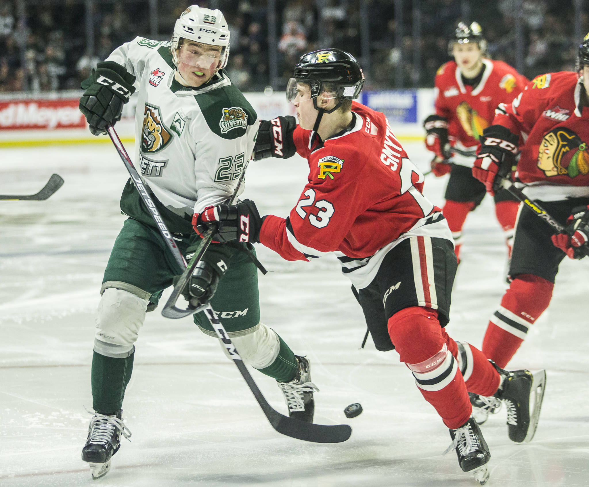 Silvertips’ Jake Christiansen fights for the puck with Winterhawks’ Kurtis Smythe during the game on Sunday, March 1, 2020 in Everett, Wa. (Olivia Vanni / The Herald)