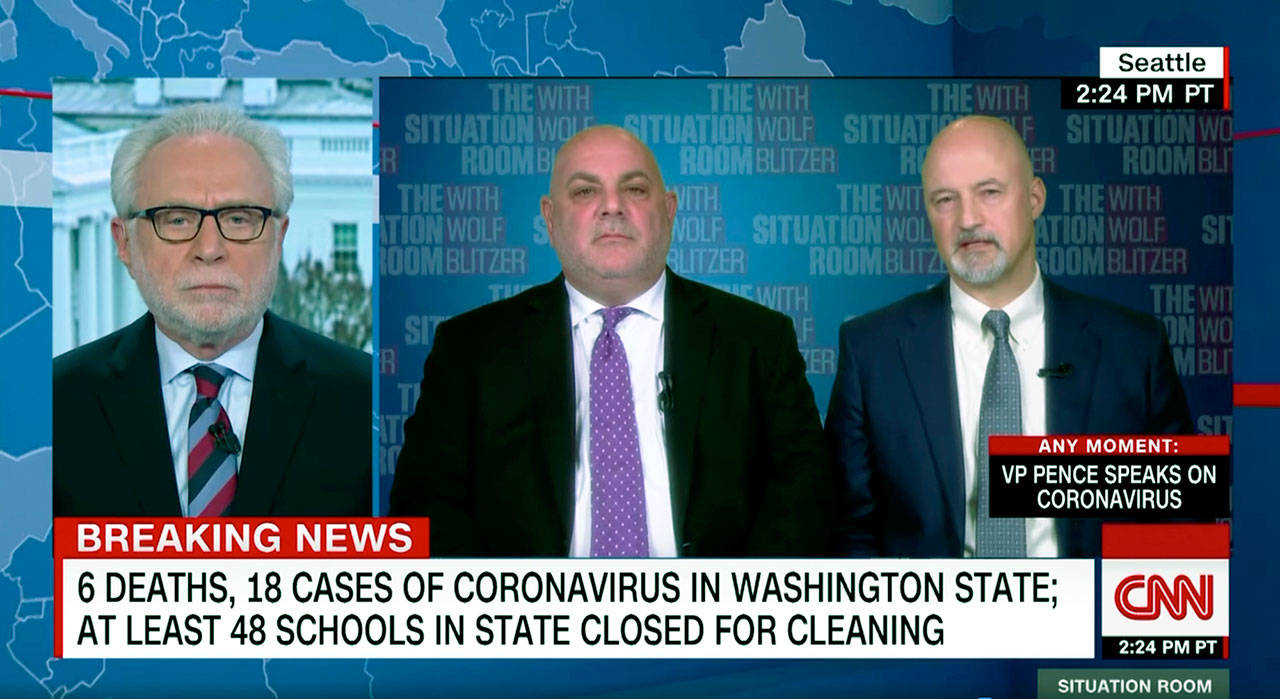 Everett Public Schools Superintendent Ian Saltzman (center) and Jackson High School principal Dave Peters (right) are interviewed by Wolf Blitzer on CNN on Monday. (CNN)