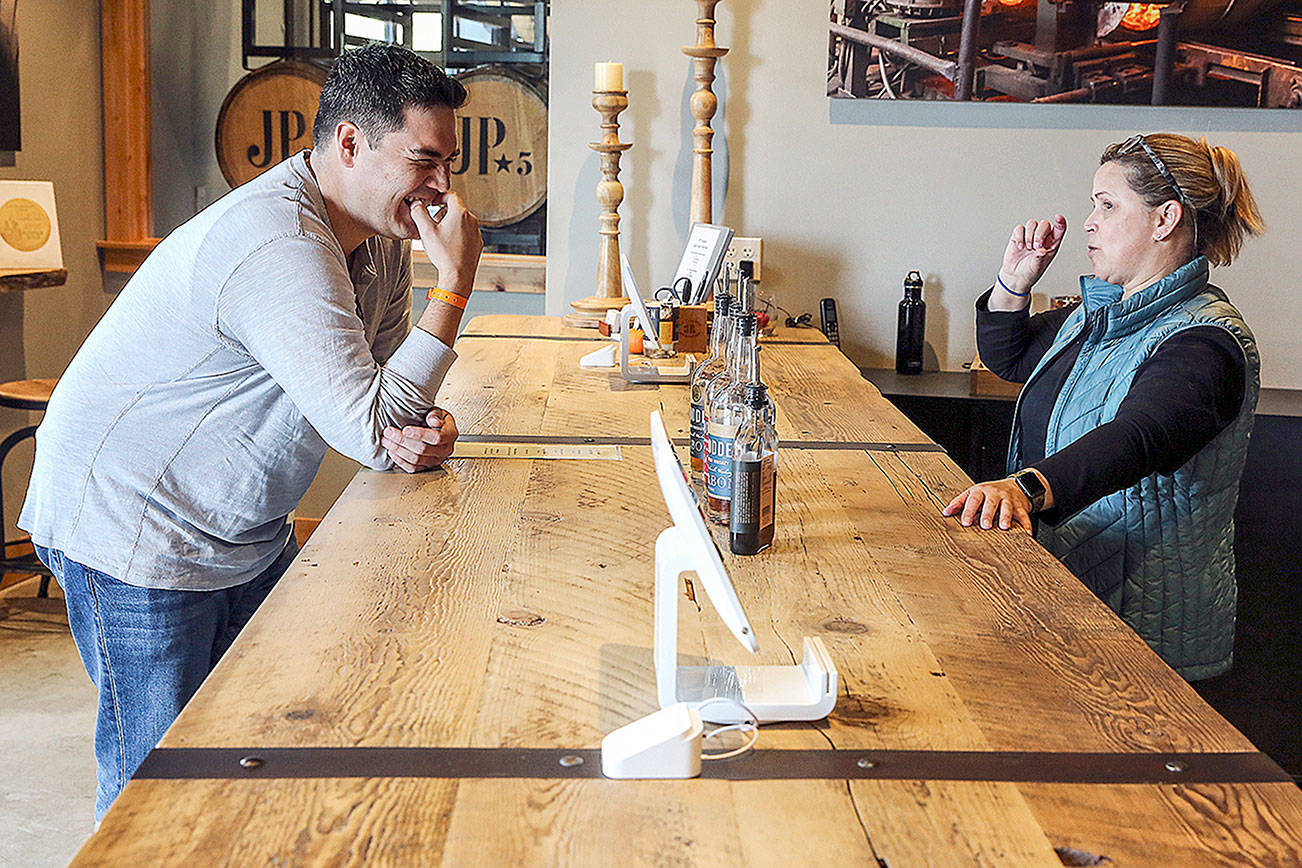 Oliver Gonzalez (left) in for a tasting talks with Mara Funk Sunday afternoon at JP Trodden in Maltby on October 6, 2019. (Kevin Clark / The Herald)