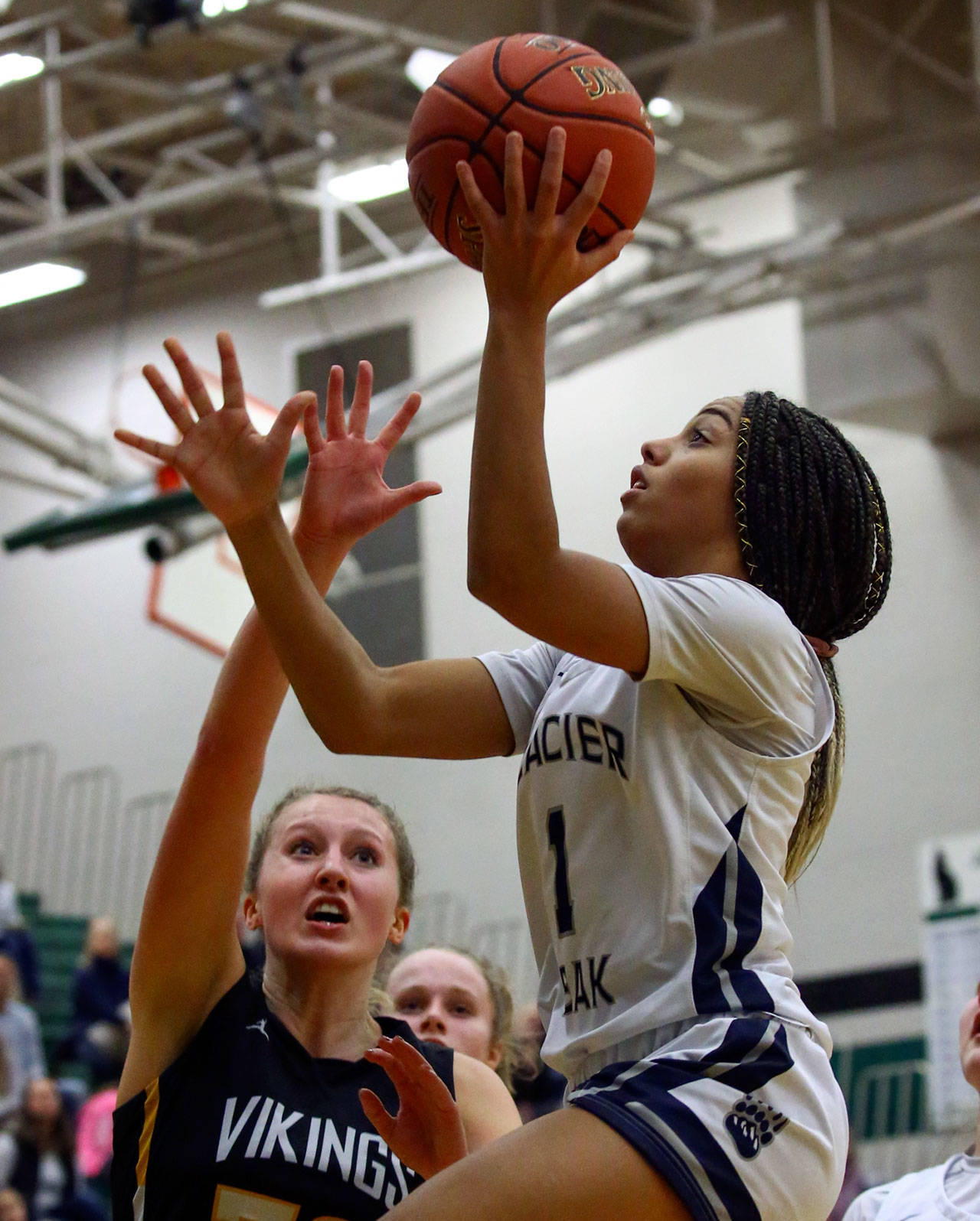 Glacier Peak’s Aaliyah Collins (right) elevates for a layup during a 4A Wes-King Bi-District Tournament game against Inglemoor on Feb. 18, 2020, at Jackson High School in Mill Creek. (Kevin Clark / The Herald)