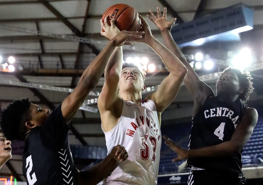 Marysville Pilchuck’s Aaron Kalab (center) attempts a shot between Central Kitsap’s Maurice Green (left) and Jo Jo Johnson (right) during a 3A boys Hardwood Classic game Wednesday morning at the Tacoma Dome. (Kevin Clark / The Herald)
