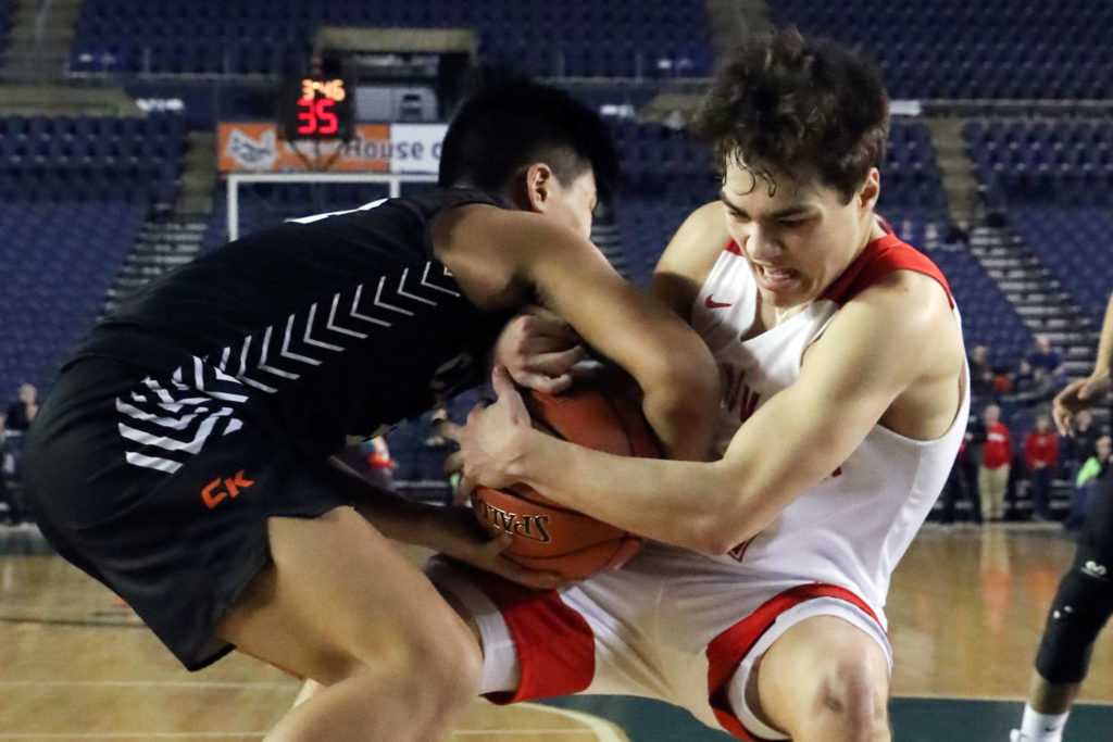 Central Kitsap’s Jay Tolentino-Balagtas (left) and Marysville Pilchuck’s Brady Phelps are tied up for a jump ball during a 3A boys Hardwood Classic game Wednesday morning at the Tacoma Dome. (Kevin Clark / The Herald)
