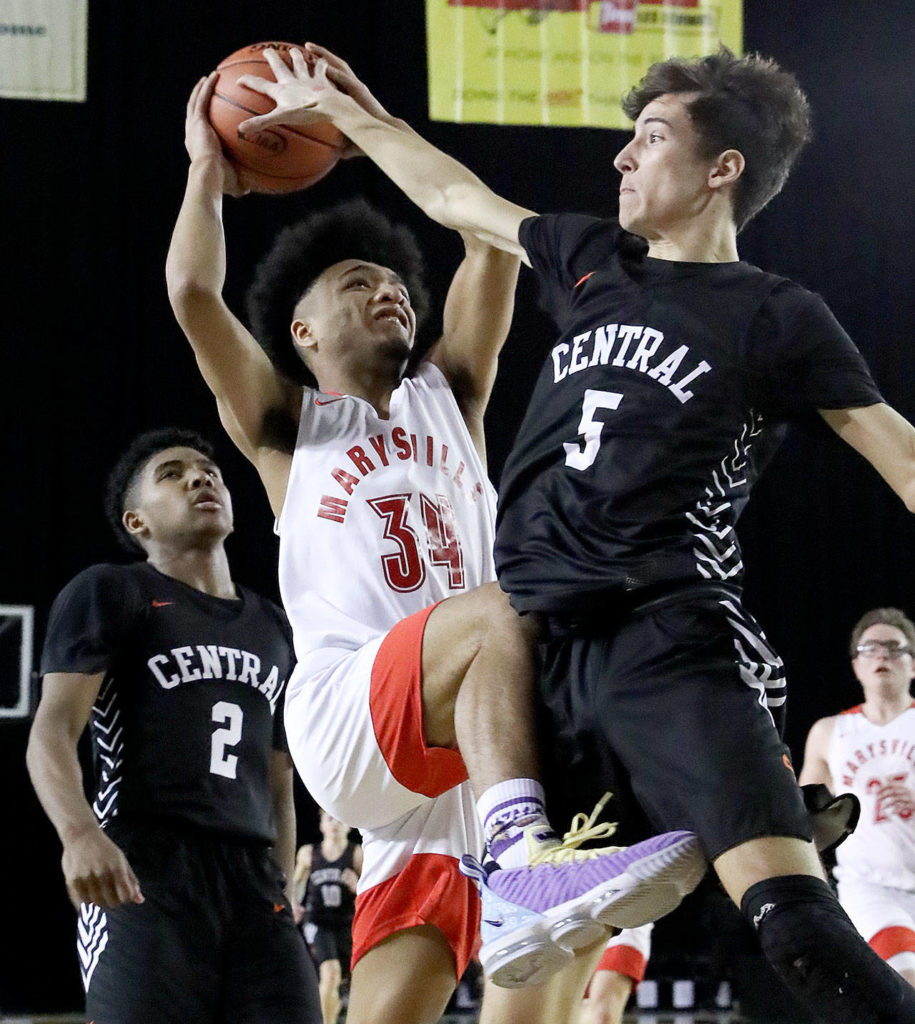 Marysville Pilchuck’s Elson Battle attempts a shot with Central Kitsap’s Elijah Labow defending during a 3A boys Hardwood Classic game Wednesday morning at the Tacoma Dome. (Kevin Clark / The Herald)
