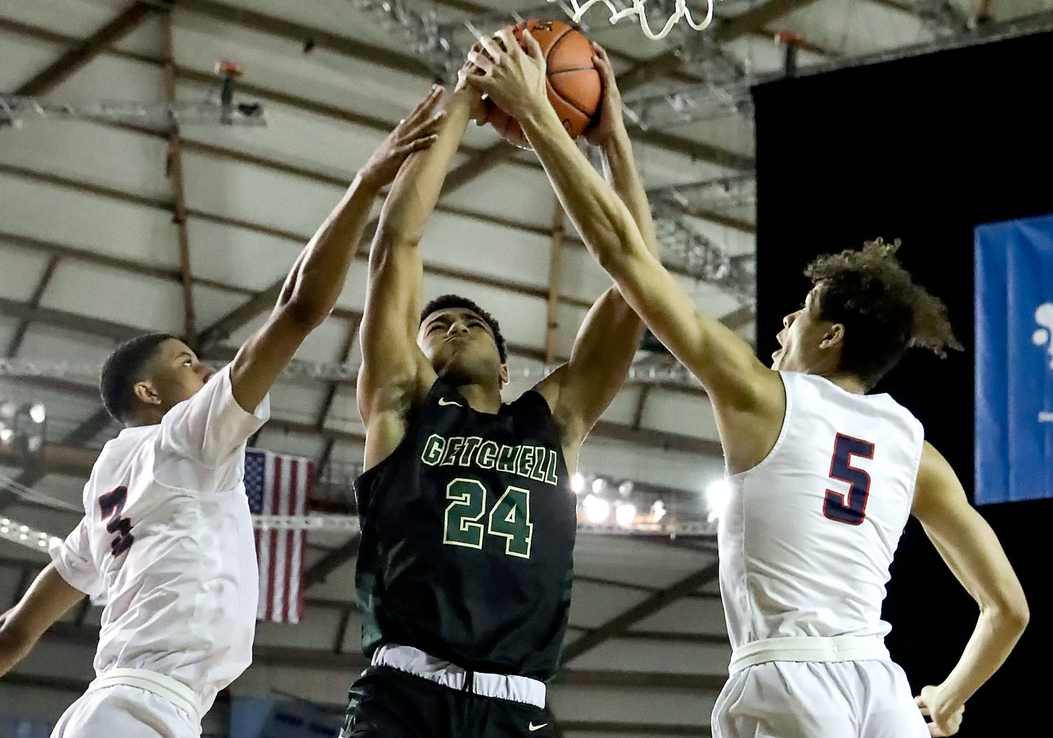Marysville-Getchell’s Malakhi Knight shot is blocked by Wilson’s Jackson Dorsey (right) and Cayden McDaniel Wednesday morning at the Tacoma Dome on March 4, 2020. Marysville-Gethchell lost to Wilson 73-52. (Kevin Clark / The Herald)