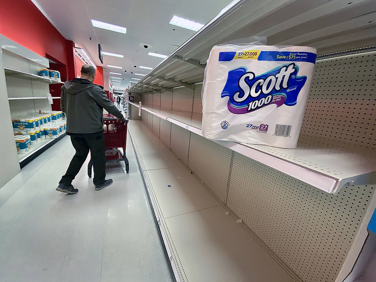 A supersized package of toilet paper was returned to the empty shelf at a Lynnwood store on Friday. (Andrea Brown/The Herald)