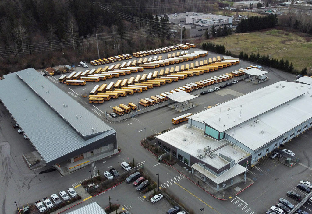 School buses are parked at the Northshore School District Transportation Center on Thursday morning in Bothell after the district closed all schools over coronavirus concerns. (Ken Lambert/The Seattle Times via AP)
