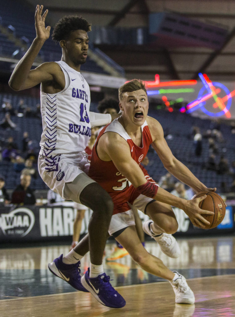 Marysville Pilchuck’s Aaron Kalab (right) drives to the hoop while being guarded by Garfield’s Tari Eason during a 3A boys Hardwood Classic quarterfinal on Thursday in Tacoma. (Olivia Vanni / The Herald)

