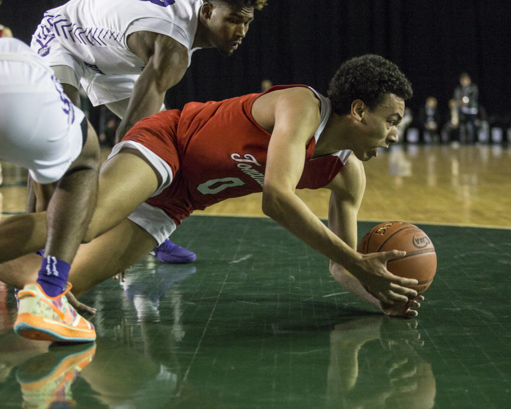 Marysville Pilchuck’s Ethan Jackson scrambles for the ball during a 3A boys Hardwood Classic quarterfinal against Garfield on Thursday in Tacoma. (Olivia Vanni / The Herald)
