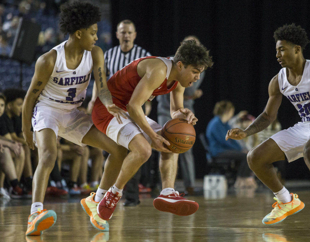 Marysville Pilchuck’s Brady Phelps reacts to being fouled by Garfield’s Koren Johnson during a 3A boys Hardwood Classic quarterfinal on Thursday in Tacoma. (Olivia Vanni / The Herald)
