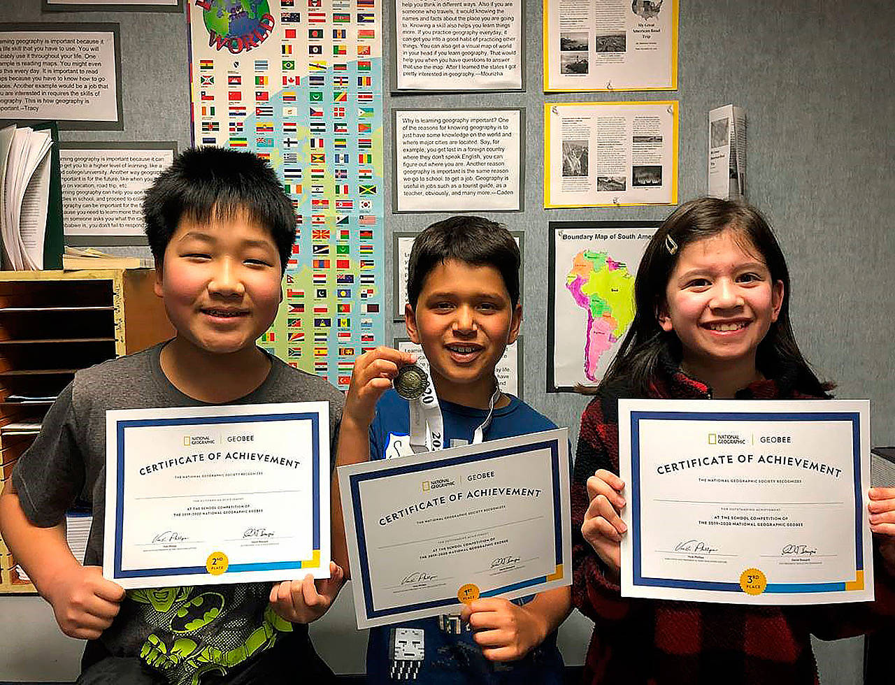 Andy (from left) (Ji-Hoon) Park, Sorin Bulgannawar and Maddy Swanson show their joy over their certificates of achievement.