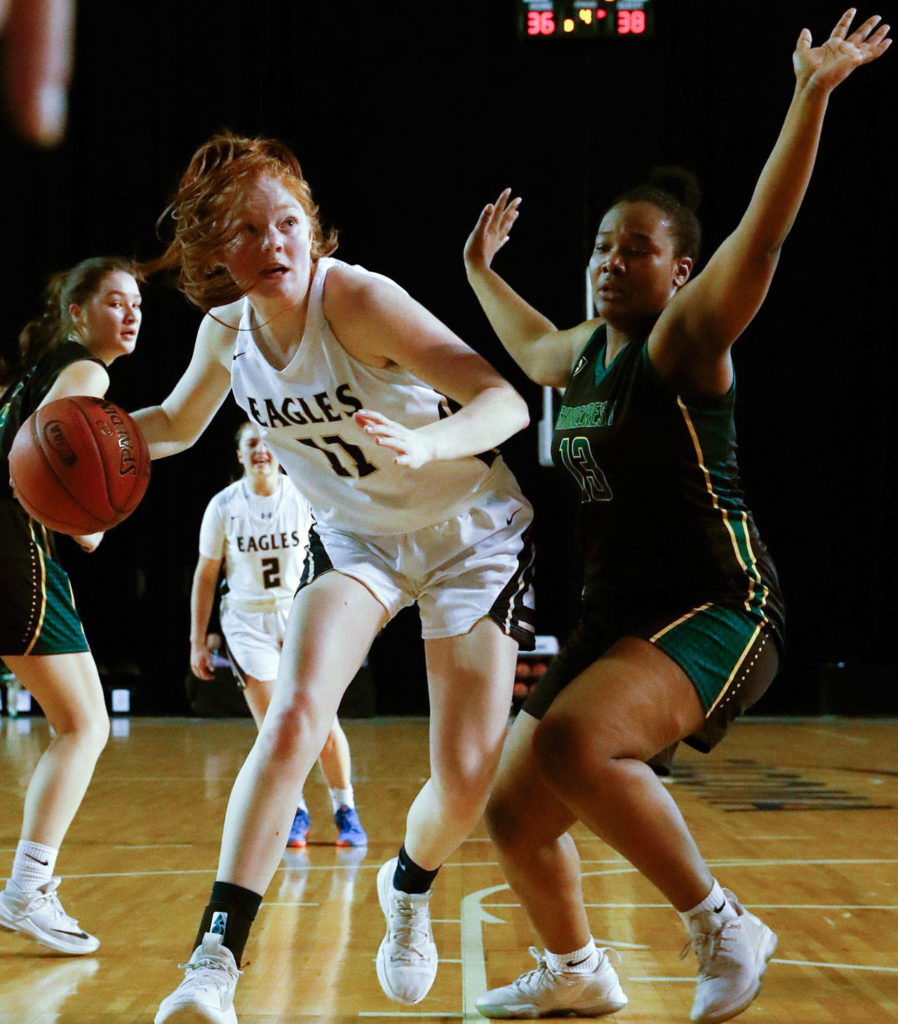 Arlington’s Makenzie Gage looks to score with Shorecrest’s Anais Kagarabi defending Thursday evening at the Tacoma Dome on March 5, 2020. Arlington won 50-49 to advance to the semifinals. (Kevin Clark / The Herald)
