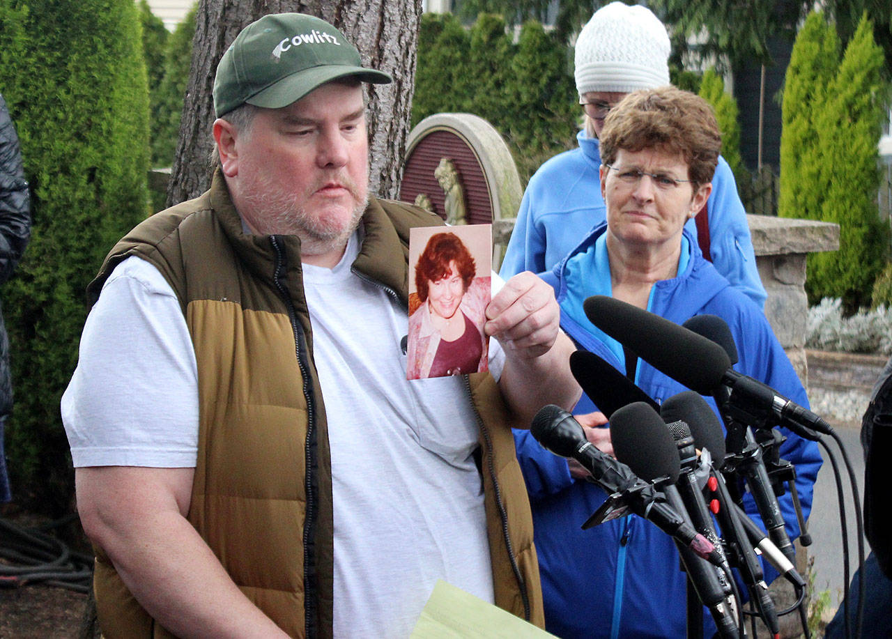 Mike Weatherill holds up a picture of his mother, Louise, at a March 5 press conference. Louise, who was a resident of Life Care, died March 4. It is unknown whether she died from coronavirus. (Blake Peterson / Bothell-Kenmore Reporter)