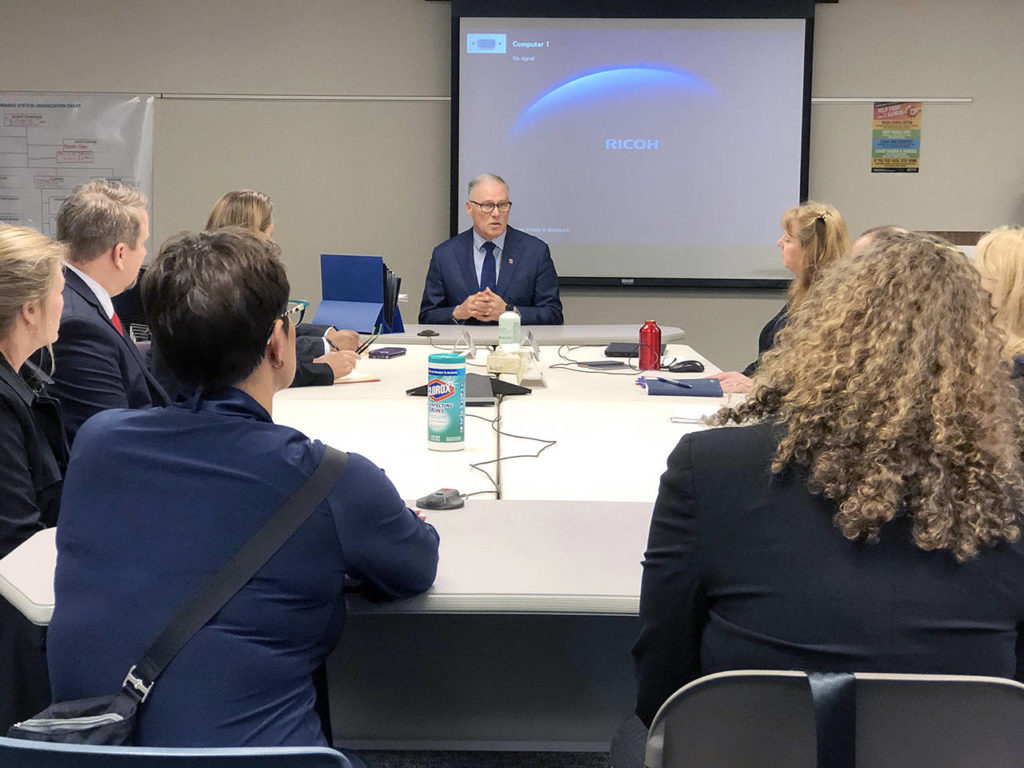 Andy Bronson / The Herald
Gov. Jay Inslee meets with local officials Friday at the Snohomish Health District in Everett.
