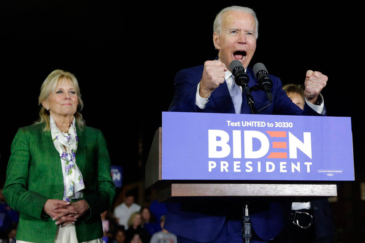 Democratic presidential candidate former Vice President Joe Biden, accompanied by his wife Jill, gestures as he speaks during a Super Tuesday rally, March 3 in Los Angeles. (Marcio Jose Sanchez / Associated Press)