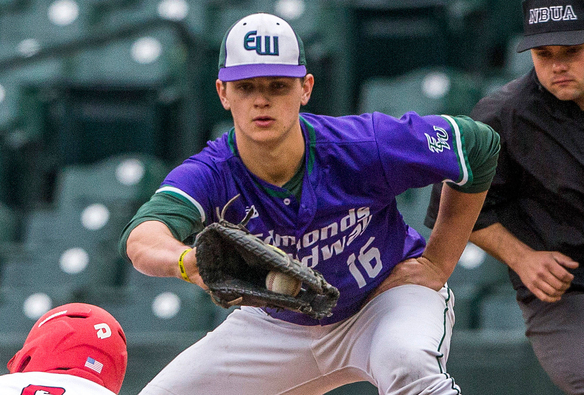 Edmonds-Woodway’s Thomas Blahous holds a runner at first base during a game against Mount Si on April 7, 2019, at T-Mobile Park in Seattle. (Olivia Vanni / The Herald)