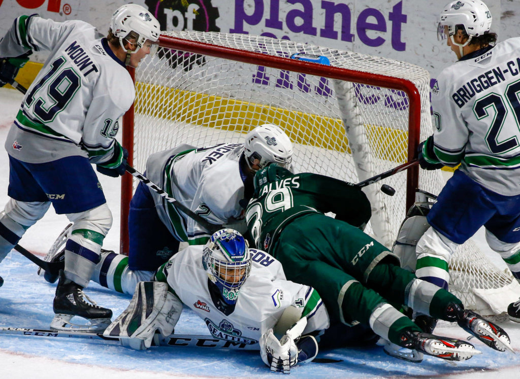 Everett’s Gage Goncalves scores a goal over Seattle’s Roddy Ross in the second period Sunday evening at ShoWare Center in Kent on March 8, 2020. The Silvertips won 3-2. (Kevin Clark / The Herald)
