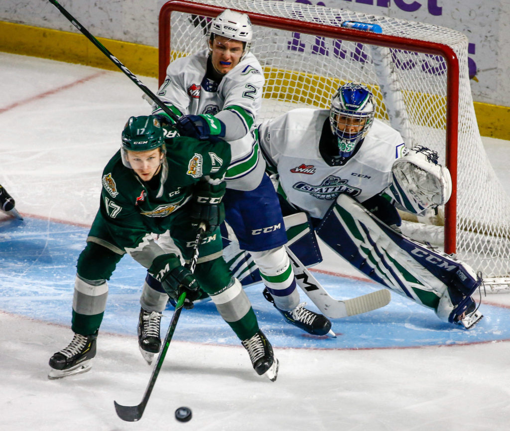 Everett’s Jackson Berezowski looks to set up a play with Seattle’s Simon Kubicek and goalie Roddy Ross defending Sunday evening at ShoWare Center in Kent on March 8, 2020. The Silvertips won 3-2. (Kevin Clark / The Herald)
