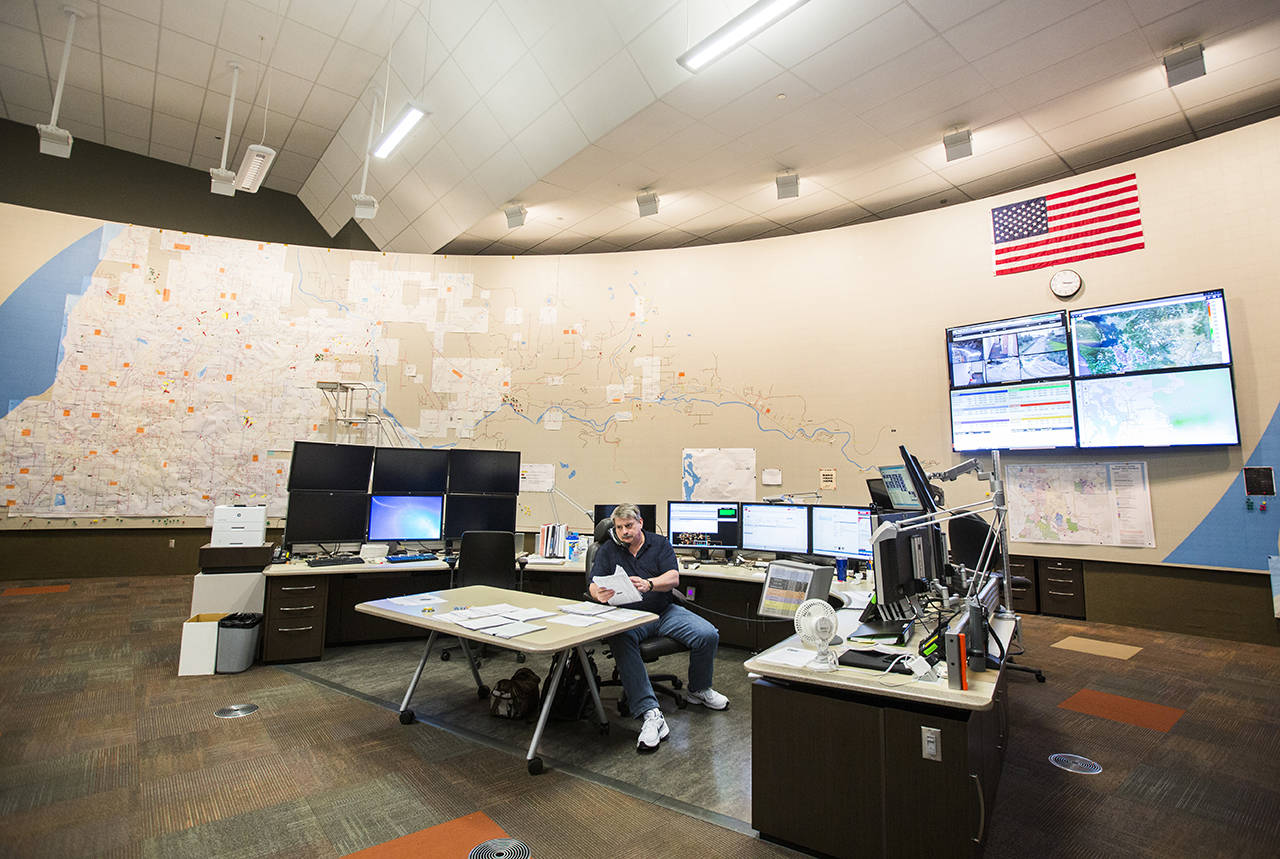 A Systems Operator works at a desk inside the Storm Center the Snohomish County PUD Operations Center on Nov. 14, 2018 in Everett. (Olivia Vanni / Herald file)