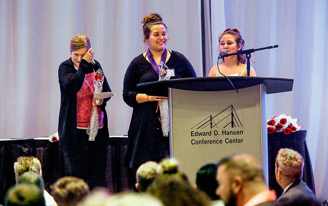 At the Cocoon House Butterfly Celebration in 2018, Jennifer McCabe (left) wipes a tear as her daughters Vanessa Bassi and Jayla Bassi speak to the crowd. The event has been canceled this year due to the coronavirus outbreak. (Dan Bates/ The Herald)