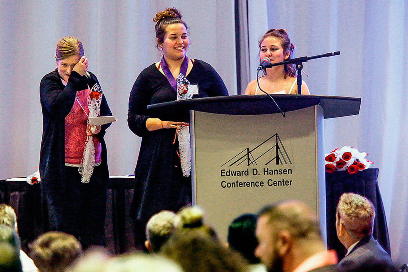 At the Cocoon House Butterfly Celebration in 2018, Jennifer McCabe (left) wipes a tear as her daughters Vanessa Bassi and Jayla Bassi speak to the crowd. The event has been canceled this year due to the coronavirus outbreak. (Dan Bates/ The Herald)