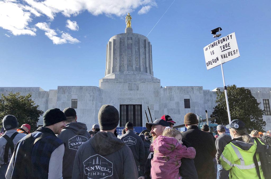 In this Feb. 6 photo, demonstrators protest against a cap-and-trade bill aimed at stemming global warming at the Oregon State Capitol in Salem. (AP Photo/Andrew Selsky, File)
