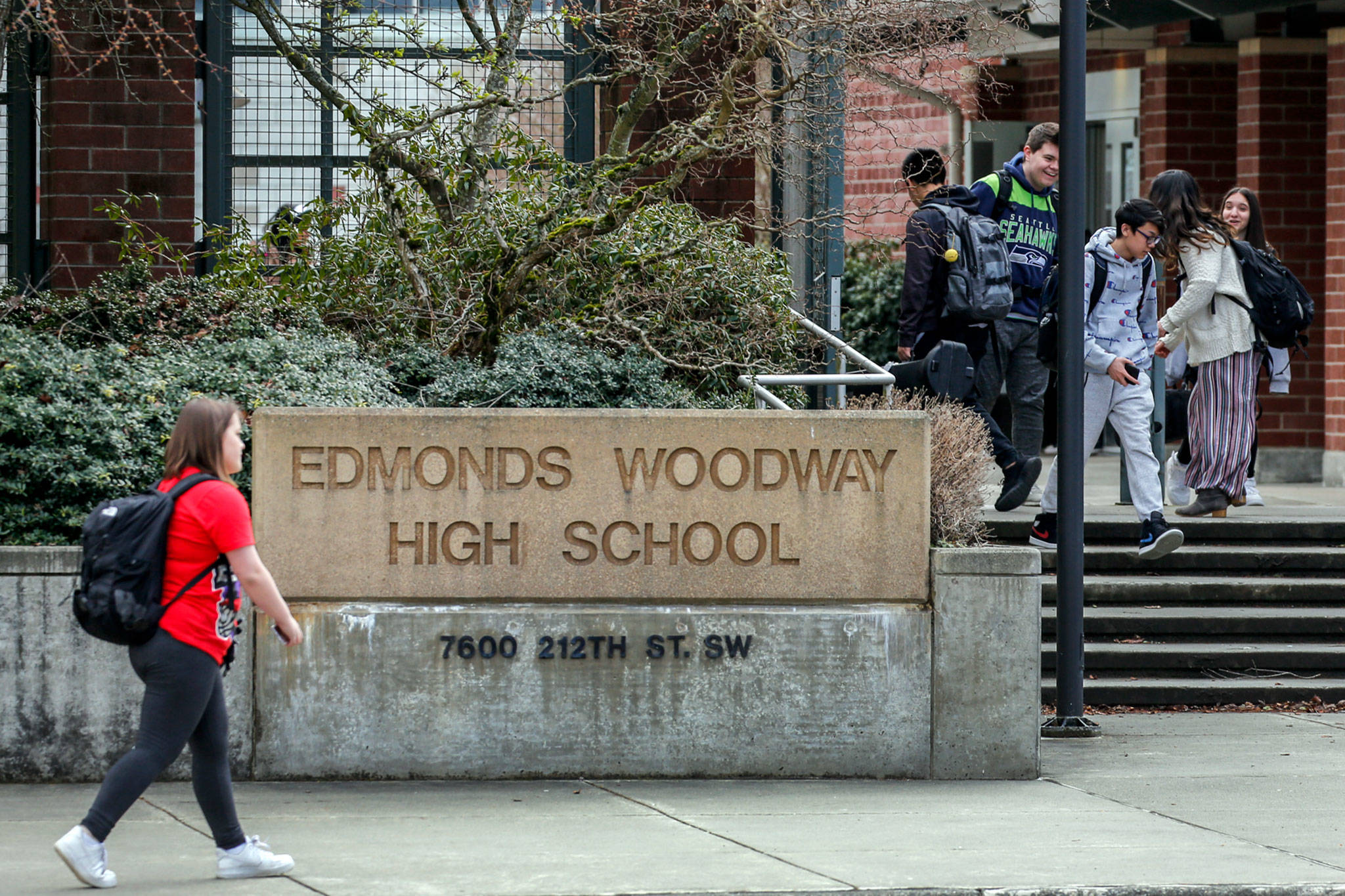 Students make their way after school at Edmonds-Woodway High School on Thursday. All public and private schools in Snohomish, King and Pierce counties must close for six weeks. (Kevin Clark / The Herald)
