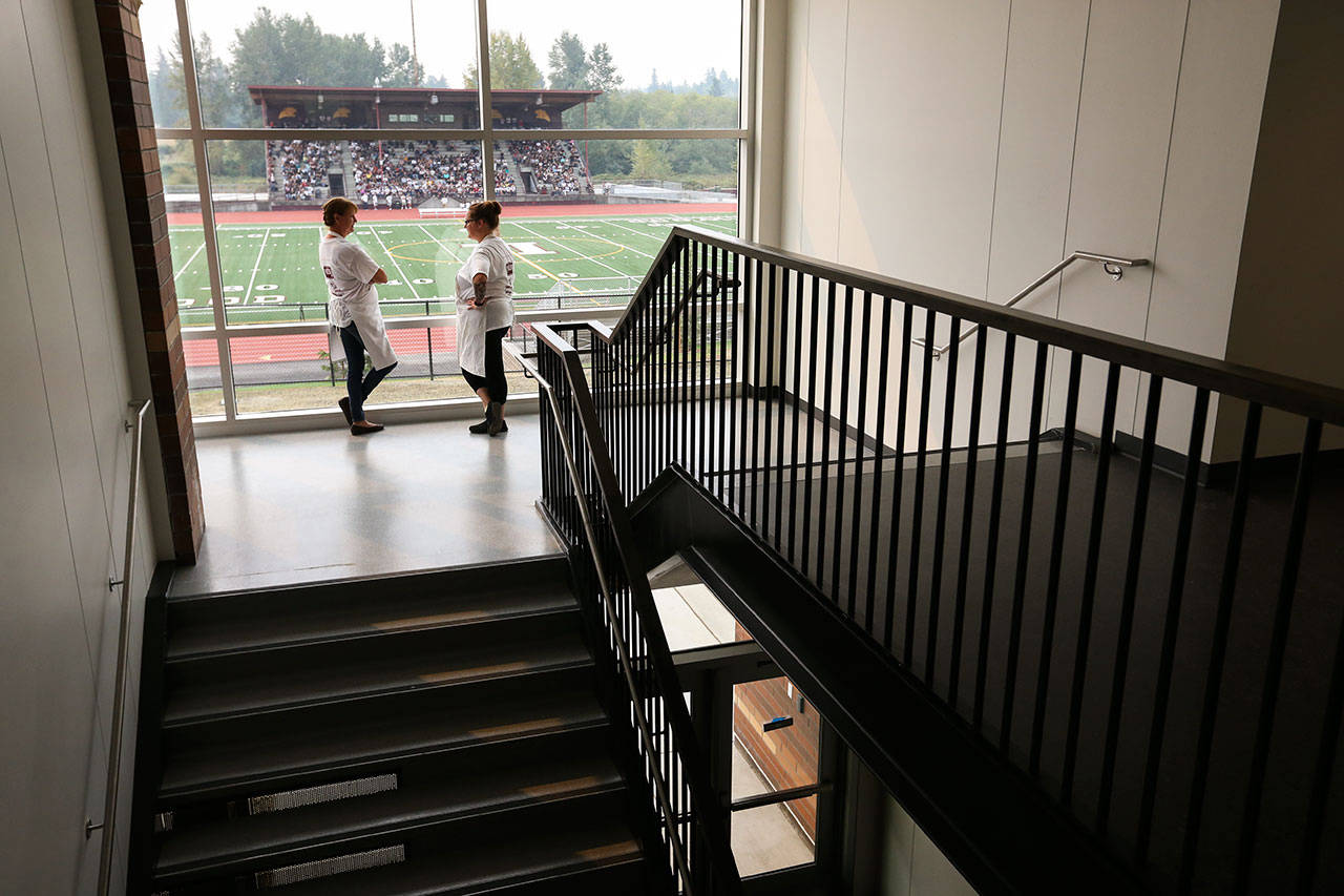 This 2017 photo shows kitchen staffers Laura Cannon (left) and Kari Albin in a stairway at Lakewood High School. (Andy Bronson / Herald file)