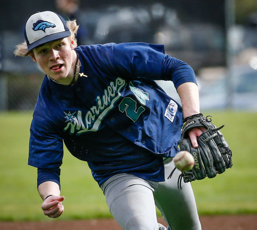 Meadowdale’s Cole Duncan chases down a ground ball during practice Thursday afternoon at Meadowdale High School in Lynnwood. (Kevin Clark / The Herald)
