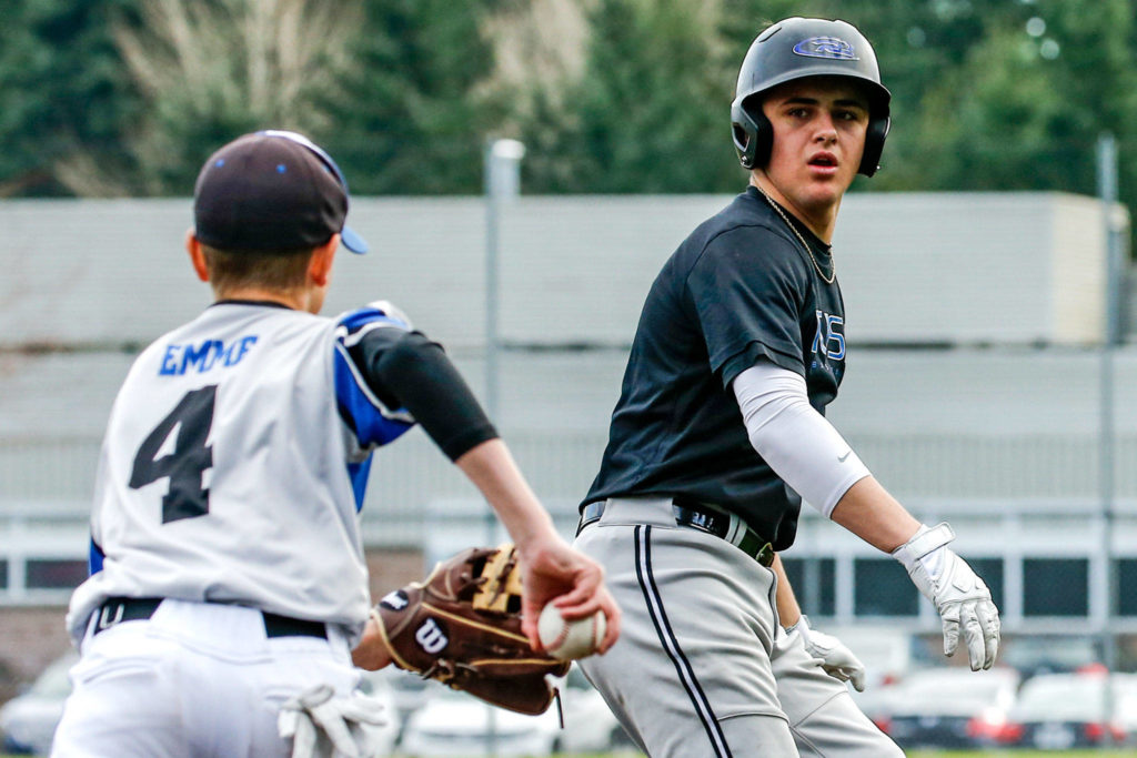 Meadowdale’s Cutter Buchea (right) is chased by third baseman Nick Emme during practice Thursday at Meadowdale High School in Lynnwood. (Kevin Clark / The Herald)
