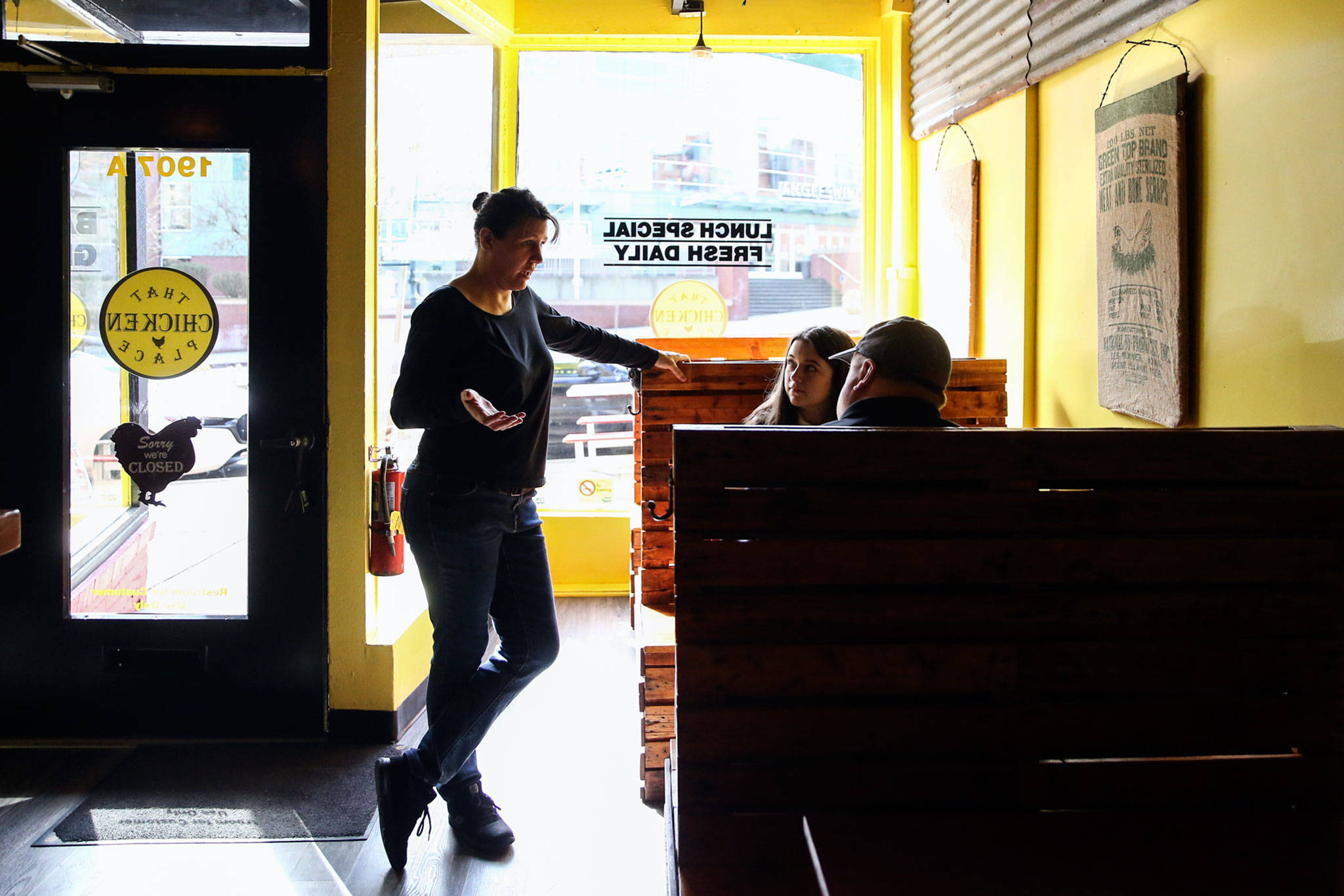 Brandy Wahlstrom, owner-operator of That Chicken Place on Hewitt Avenue in Everett, takes an order Saturday. All restaurants and bars in the state were ordered to close Tuesday. (Kevin Clark / The Herald)