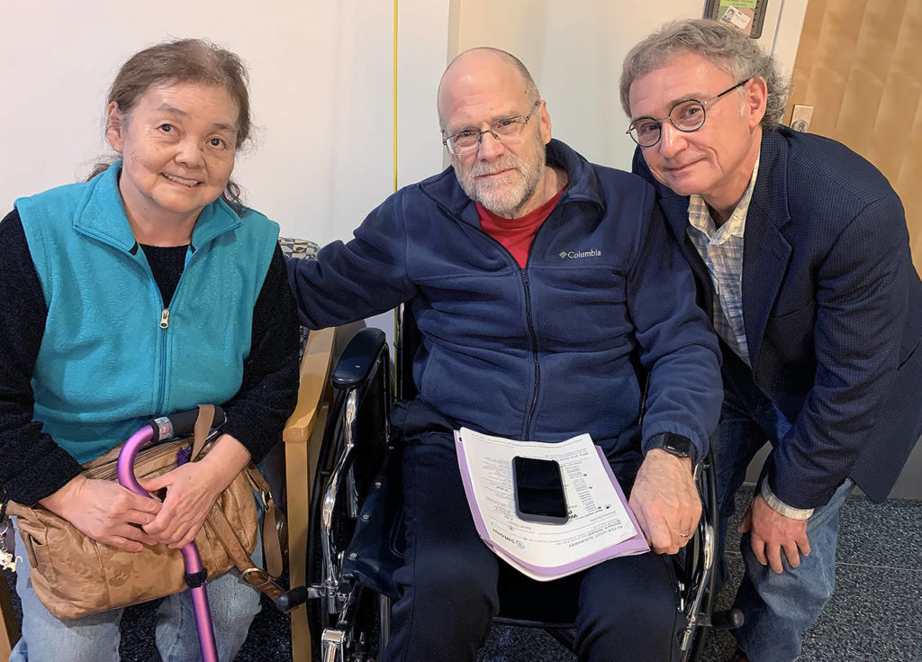 Yuki Tolmie, Stan Orchard and Doug Tolmie. Yuki Tolmie, 72, has been hospitalized at Providence Regional Medical Center Everett with a rare neuromuscular disease since Feb. 22. Her family wasn’t allowed to see her for two days because of coronavirus concerns. (Courtesy of Doug Tolmie)
