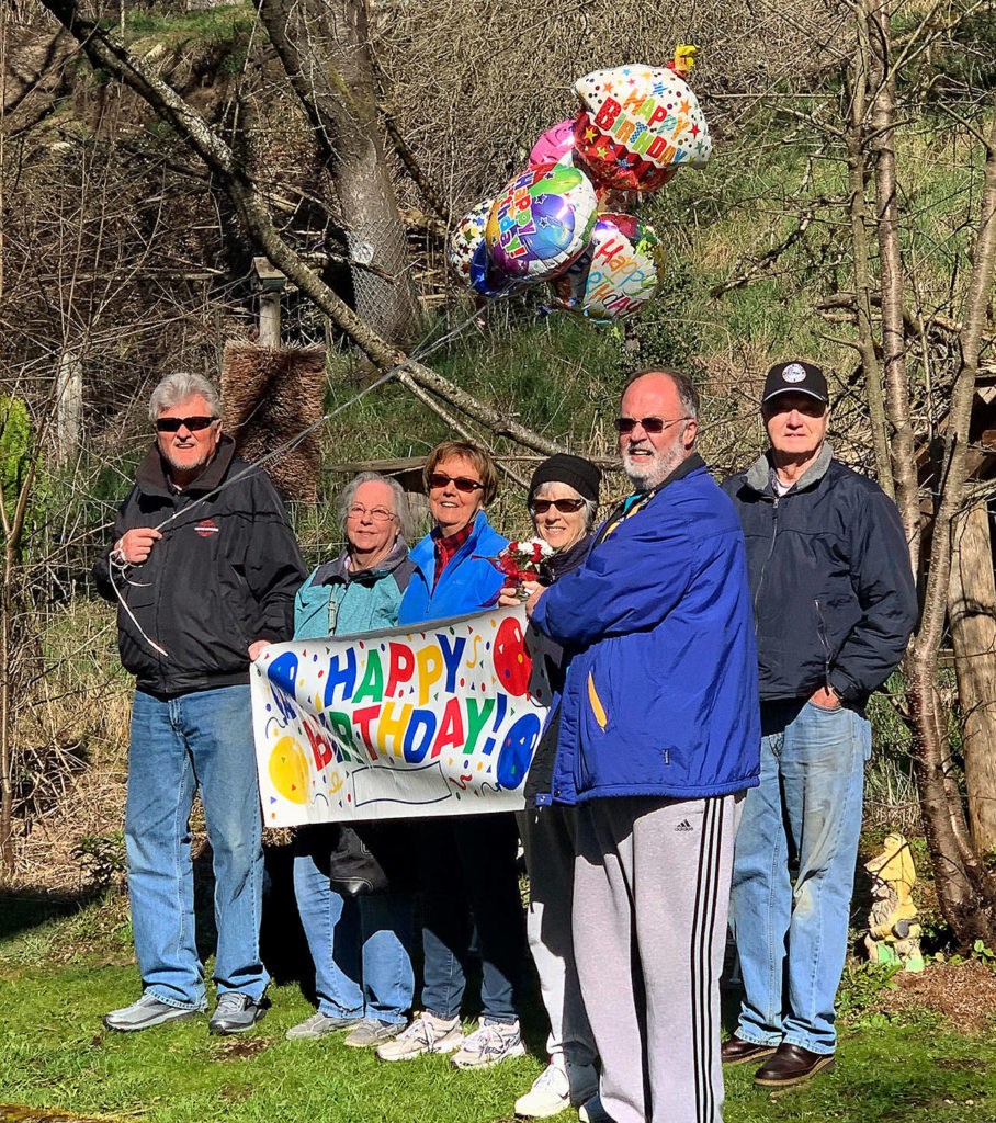 Outside Olympic Place, an Arlington senior community, Carolyn Ross’s children and their spouses gathered to wish her a happy 96th birthday Monday although they couldn’t visit. They are, from left: Jeff Skodje, Nancy Ross, Cathy Skodje, Robin Ross, Jeff Ross and Rick Ross. (Vanessa Ross photo)
