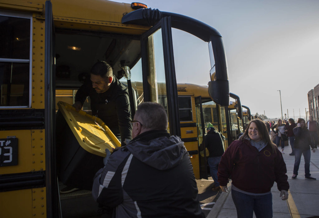 Meals are loaded onto buses for delivery on Wednesday in Marysville. (Olivia Vanni / The Herald)
