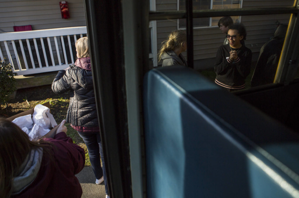 Children lineup next to the bus to receive their meals on Wednesday in Marysville. (Olivia Vanni / The Herald)
