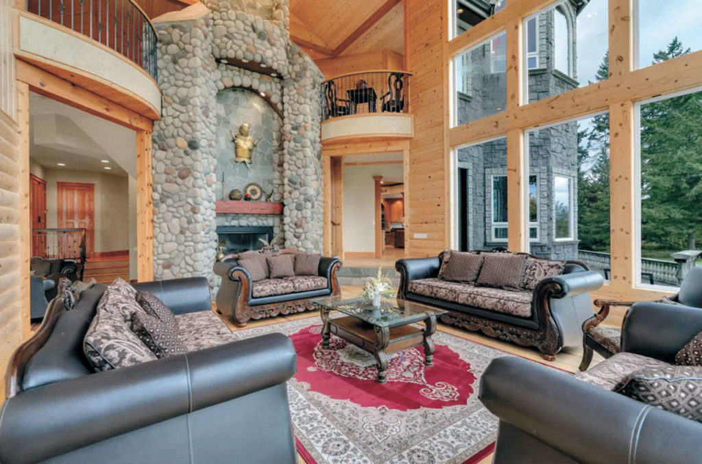 The $4.1 million home has four living rooms, including this formal living room with a fireplace. (Graystone Castle)

